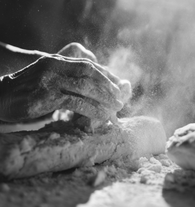 Hands shaping a cake of nuruk, dusted with flour